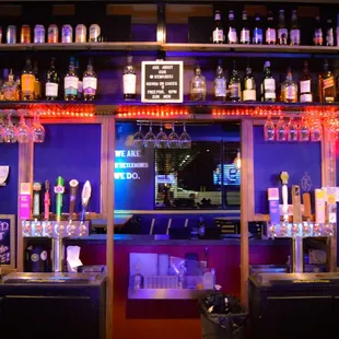 a bar with a lot of bottles of alcohol