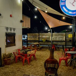 a patio area with tables and chairs