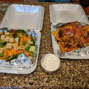 two takeout containers of food