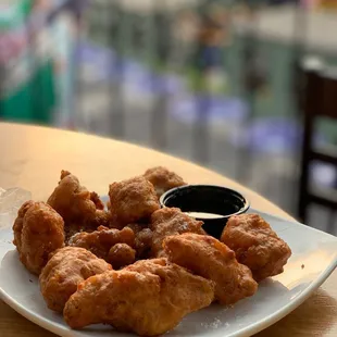 a plate of fried chicken with dipping sauce