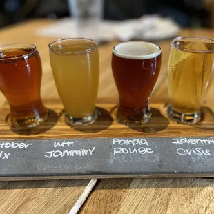 a flight of beers on a slate board