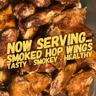 a pile of chicken wings with the words now serving smoked hop wings tasty smokey healthy