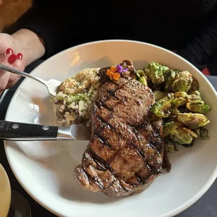 Ribeye with mushroom risotto and fried brussel sprouts.
