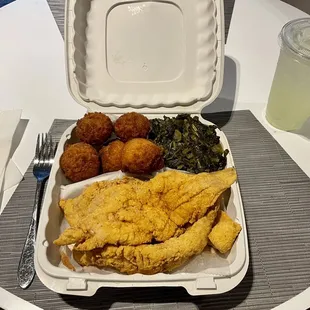a tray of fried fish and vegetables