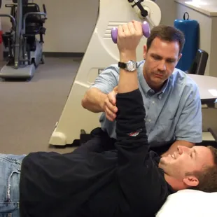 Troy reviewing home exercise with a patient.