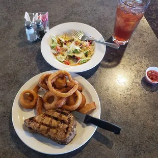 Pork chop, onion rings and salad