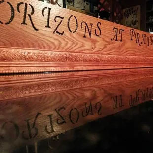 a reflection of a wooden sign