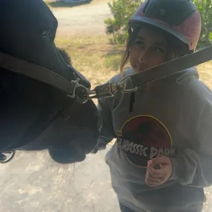 Helping brush the horse softly.
