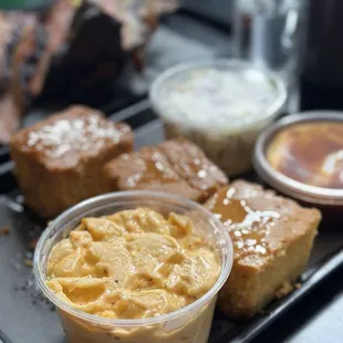 Mac and cheese, cornbread, coleslaw, and sauce