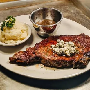 a plate of steak and mashed potatoes