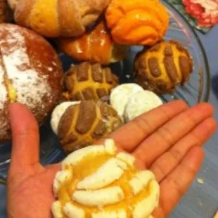 a person holding a plate of pastries