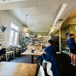 people sitting at tables in a restaurant