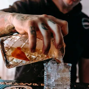 a bartender pouring a drink