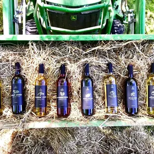 a row of bales of hay with a tractor in the background