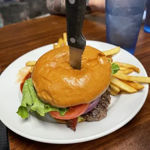 a burger with a knife stuck in it