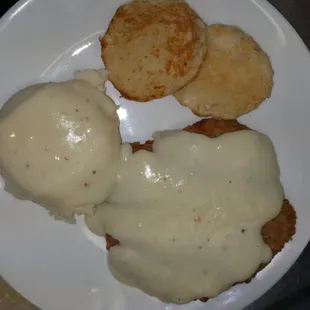 Chicken fried steak with mashed and gravy, grilled southern buttermilk biscuit
