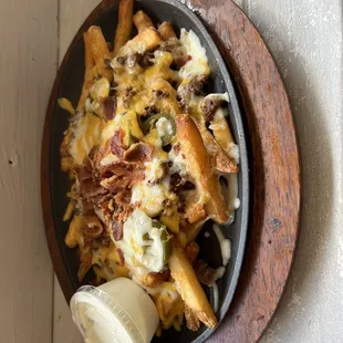 a plate of fries with cheese and meat