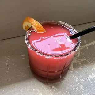 a drink with a slice of orange on the rim