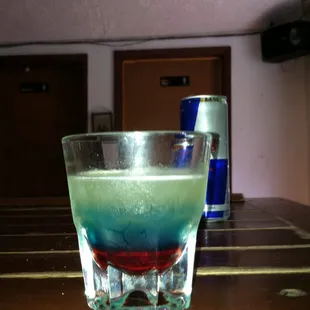 a blue and green drink in a glass