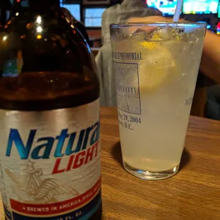 a bottle of natural light and a glass of lemonade