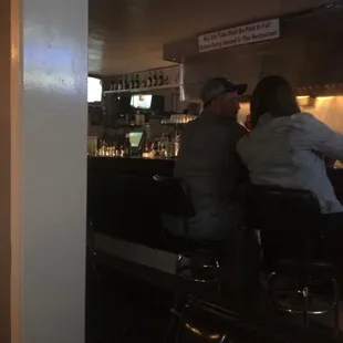 Nice short bar with seating and 2 small tv's.