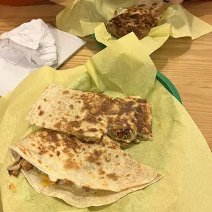 a person eating quesadillas at a table