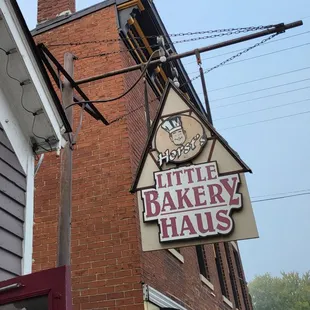 a brick building with a sign that says little bakery haus