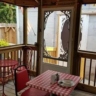 a table and chairs on a porch