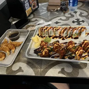 Snow crab roll top picture, spicy tuna crisp rice bottom and gyoza on left.