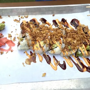 a piece of sushi on a tray