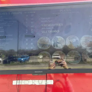 The menu and my reflection lol 03/23/22. It's hard to capture the TVs in the daytime.