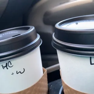 two cups of coffee in a car