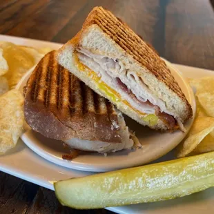 Turkey Club
white bread, turkey, bacon, cheddar cheese, 
banana peppers &amp; chipotle mayo; grilled