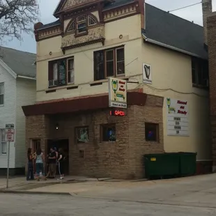 people standing outside of a building