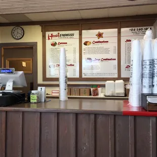 a coffee shop counter with coffee cups on it