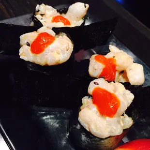 a plate of sushi and a strawberry