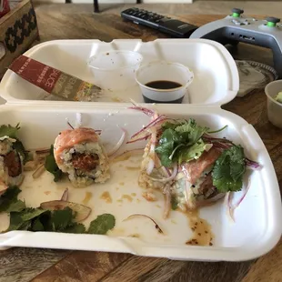 a plate of sushi rolls and a bowl of salad