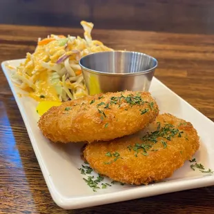 a plate of fried fish and coleslaw