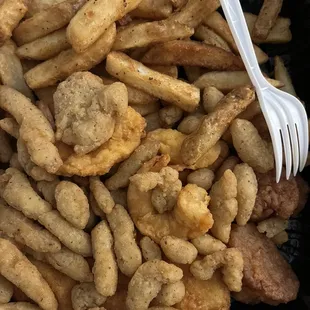 a plastic fork and a container of fried food
