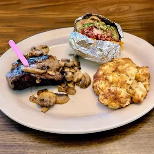 Filet mignon with mushrooms, baked potato, and crab cake
