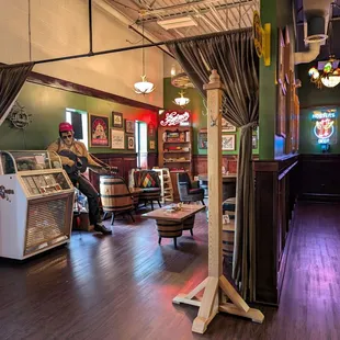 Looking from the corner of the bar: games &amp; juke box to the left and restrooms to the left.
