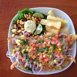 Mixed seafood of shrimp, squid, and fish in a sweet onion, corn, tomato,  cilantro topping - refreshing!.  Great fried yuca!