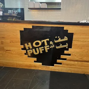 a sign on a counter in a restaurant