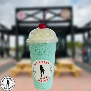 a cup of ice cream with a cherry on top