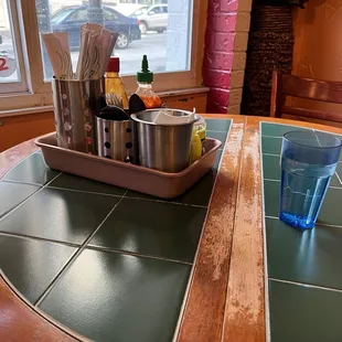 a table with drinks and condiments