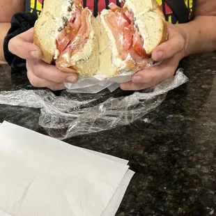 a woman holding a sandwich