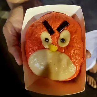 an angry bird shaped doughnut in a box