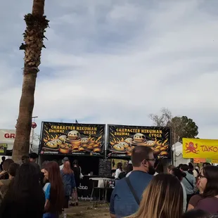 a crowd of people at a food stand