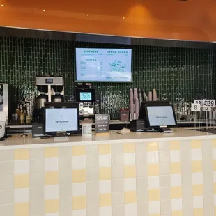 a coffee shop counter with multiple computers