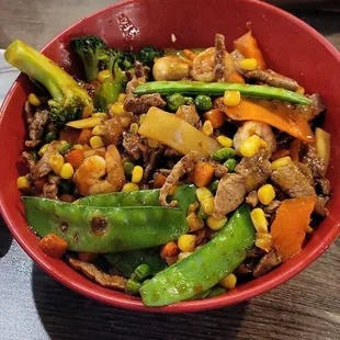 Beef and shrimps with fried rice broccoli, carrots, peas corns, bell pepper, garlic sauce and mongolian sauce was amazing.